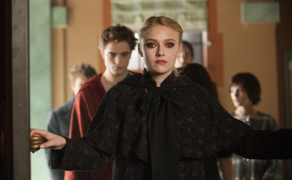 Screenshot from New Moon, with Dakota Fanning, with red eyes, solemnly opening a door
