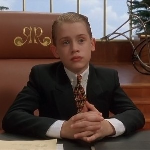 Screenshot from Richie Ritch, with Richie wearing a suit and sitting at a desk
