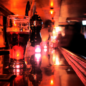 A pint glass on a bar countertop