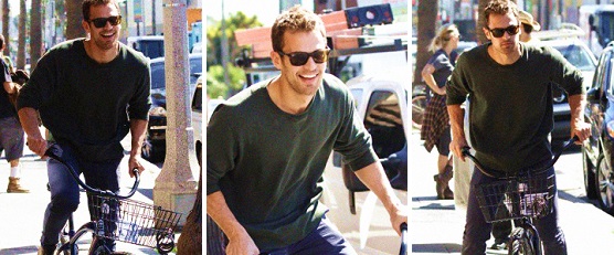 Theo James riding a bike