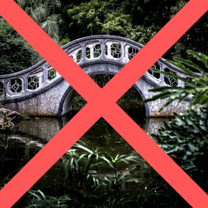 A stone bridge over water with a big red X marking it out