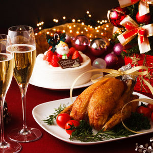 Table with flutes of champagne, Christmas cake, chicken, and presents