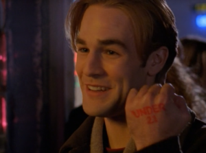 Dawson smiling ironically with a bad haircut and "Under 21" stamped on his hand