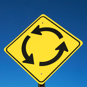 A traffic sign showing a roundabout