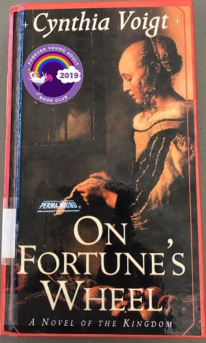 Cover of On Fortune's Wheel, with a girl wearing a medieval style dress and reading
