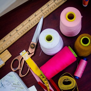 Ruler, scissors, spools of thread, and measuring tape