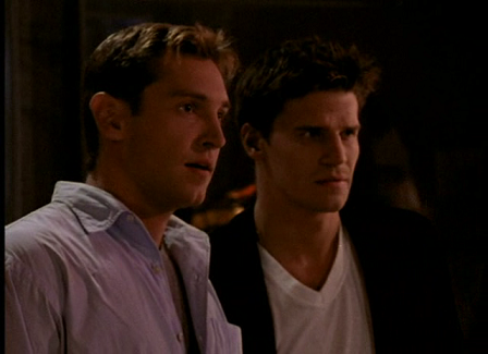 A blonde broad-shouldered guy (Owen) standing next to Angel