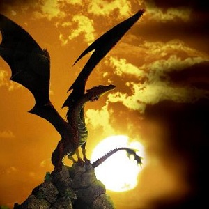 A dragon perched on a mountain top with his wings spread with the sun setting in the background