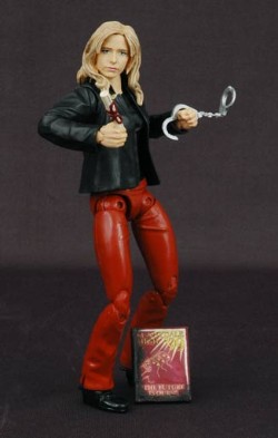 Buffy as an action figure in red leather pants and a black leather jacket, holding weapons