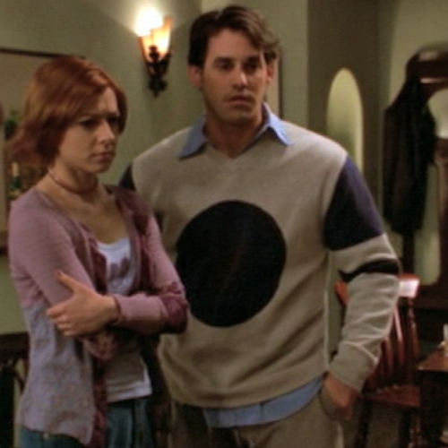 Xander wearing a sweater with a giant black dot in the middle.