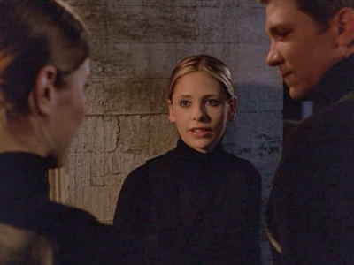 Buffy looks at Riley with his new wife.