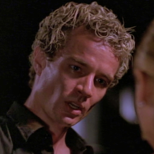 Spike with bleached blonde curls looking like ramen on his head a la Justin Timberlake in the early 2000s