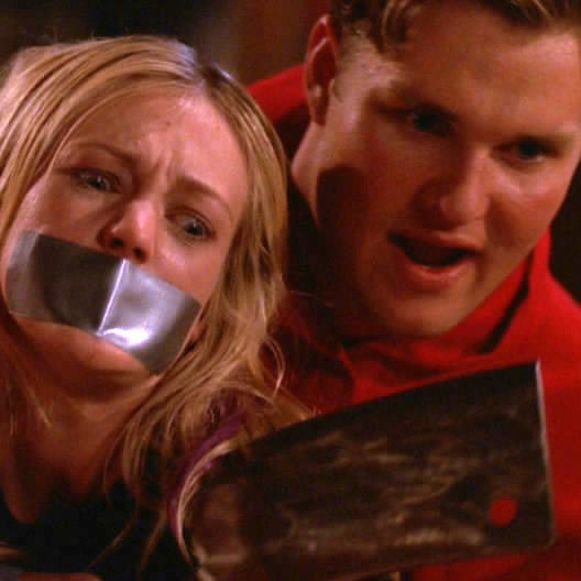 Zachery Ty Bryan as Peter, threatening a tied up Cassie with tape over her mouth