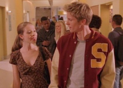 Dawn happily walks down the Sunnydale High hallway with a blandly handsome blonde boy in a letterman jacket