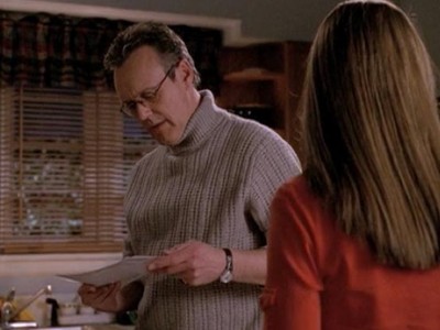 Giles reading a paper and looking hot in a grey turtleneck sweater