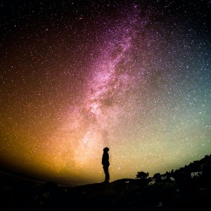 Silhouette of person standing under starry sky