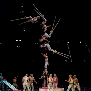 Acrobats on stilts flipping in the air 