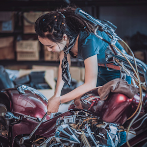 Woman mechanic working on a motorcycle