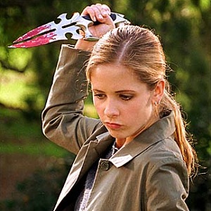 Buffy Summers holding a bloodied knife above her head