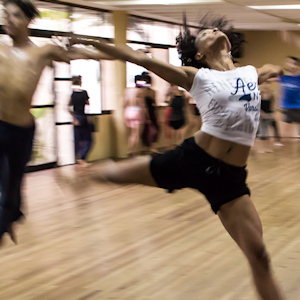 Woman leaping in a dance class