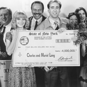 Nic Cage holding a large check from the movie It Could Happen to You