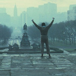 Rocky raising his fists on the steps of the Philly Museum of Art.
