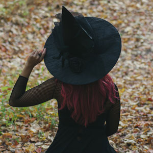girl wearing black in a pointy witch hat