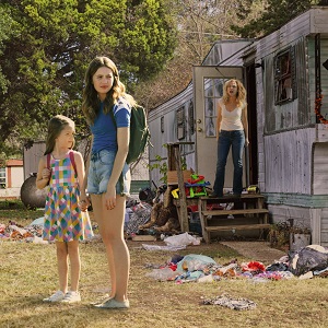 Heather and Lily stand outside their trailer while their mom yells at them from the door (Panic)