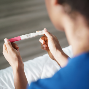 Woman looking at a pregnancy test