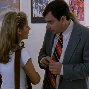 Principal Flutie and Buffy stand in the hallway.