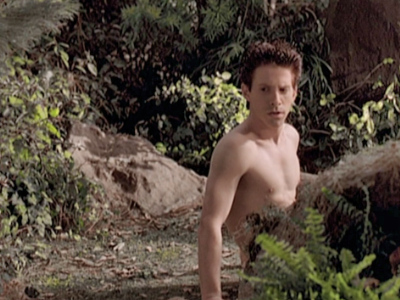 Oz wakes up naked in the middle of the forest.