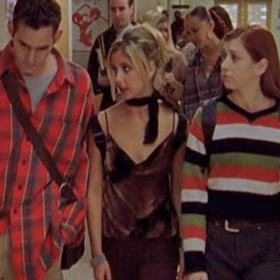 Xander, Buffy, and Willow walk down the hall.