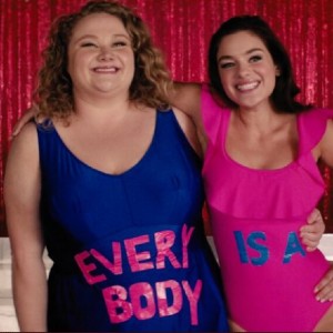 Willowdean and Ellen wearing bathing suits and smiling in a scene from Dumplin'