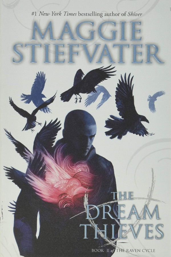 Cover of The Dream Thieves with a shadowy boy with a shaved head and ravens flying over him