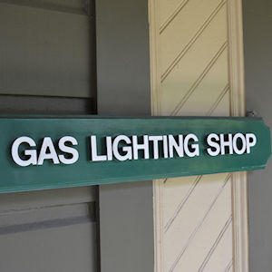 A sign on a building at the Winchester Mystery House that says "Gas Lighting Shop"