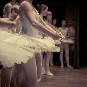 line of ballerinas in tutus on stage