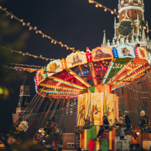 Fair/carnival lights at night and a spinning swing ride