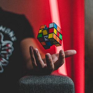 Person tossing a Rubik's cube into the air