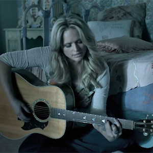 Miranda Lambert playing a guitar in the music video for "The House That Built Me"
