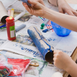 People painting with various crafts on a table