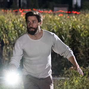 John Krasinski walking through a cornfield at night with a flashlight from A Quiet Place