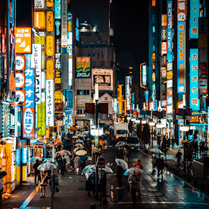 Brightly lit street of Tokyo with brightly colored signs.