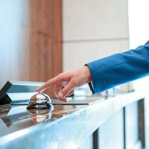 hand ringing bell at hotel front desk