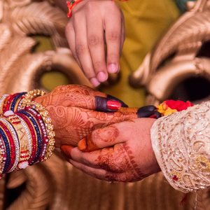 The hands of an Indian couple during their wedding ceremony