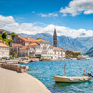 Buildings and a boat in the harbor in Montenegro