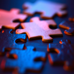 Close up of blue and pink shaded puzzle pieces