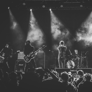 Rock band playing on stage to crowd