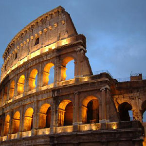 The Roman coliseum lit up at dusk