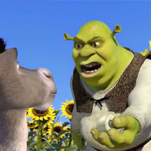 Shrek holding an onion out to Donkey