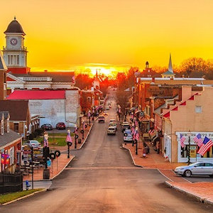 A yellow sunset on the main street of a small town